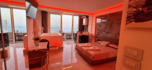 a bedroom with a bed and a desk with a television at Suite Imperial in Taormina