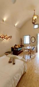 a bedroom with a bed and a table and a dining room at Aliori art caves in Aegiali