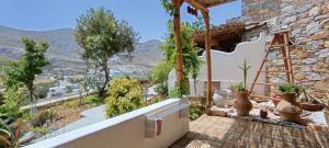 a balcony of a house with a view at Aliori art caves in Aegiali