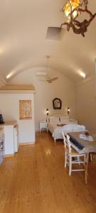 a large room with two beds and a keyboard at Aliori art caves in Aegiali