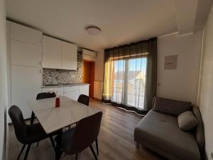 a living room with a table and a couch at Apartment Dalmare in Biograd na Moru