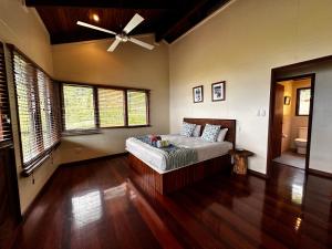 a bedroom with a bed and a ceiling fan at Latui Lodge in Savusavu +35 photos