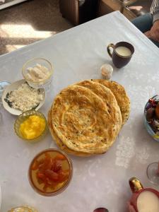 a table with a pie and other food on it at ABATAY Guest house in Ak-Say +27 photos