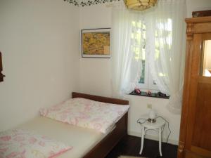 a small bedroom with a bed and a small table at Villa Luzia in Meuspath