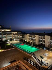 a large swimming pool in a building at night at Évasion de Rêve Luxe, Mer et Calme à la Plage des Nations, Rabat in Oulad Akkou