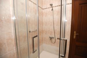 a shower with a glass door in a bathroom at Desconectaenlasriasbaixas Casa Cancela Combarro in Pontevedra +32 photos