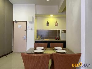 a dining room table with chairs and a kitchen at Melaka Bayou Lagoon Free 4 Waterpark Tickets! in Kampong Bukit Beruang