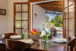 a dining room table with a bowl of fruit on it at Villa Ca Na Magdalena By homevillas360 in Pollença