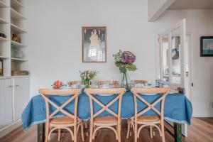 a dining room table with chairs and a blue table cloth at The Beach House in Melcombe Regis