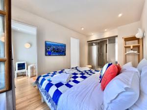 a bedroom with a large bed with blue and white sheets at Rhodania Boutique Hôtel in Geneva