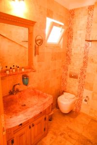 a bathroom with a sink and a toilet at Kemerlihan Deluxe Hotel in Alacati