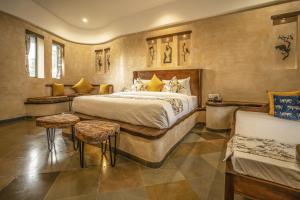 a bedroom with a large bed and a couch at Maya Luxury J Wild Resort Jawai in Dhrubana +92 photos