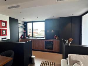 a kitchen with blue walls and a counter top at Rivendale 2 bedroom 2 bathroom with balcony and sea views in the Nogalera Complex by NAMASTE ELITE in Torremolinos