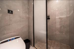 a bathroom with a shower with a toilet in it at 唯庭酒店上海虹桥天山路店 in Shanghai +6 photos
