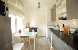a kitchen with a table and a counter top at Orgona Vendégház in Alsóörs