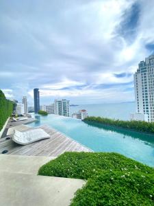 a swimming pool on the roof of a building at Baan Plai Haad in Pattaya North