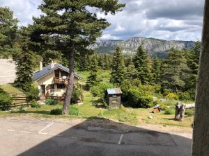 a house on the side of a road with a tree at La catane in Andon