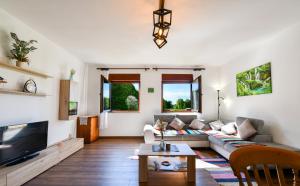 a living room with a couch and a tv at Matanovi Dvori in Saborsko