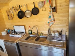 a kitchen with a sink and a stove at The Vie Llage - Authorial Suites Bungalows in Vagos