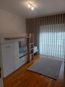 a living room with a bed and a window at apartamento Bitarães Paredes in Bitarães +9 photos