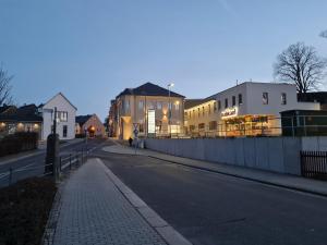 an empty street with buildings on the side of the road at Gambrinus Schneeberg in Schneeberg