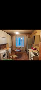 a kitchen with a stove and a table in a room at Private room at 2 km from Airport in Tallinn