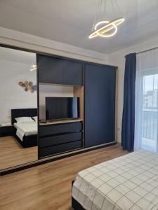 a bedroom with a bed and a large mirror at SELIS - Aparthotel in Mamaia Nord
