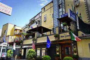 a building with flags on the side of it at Hotel Colombo in Naples