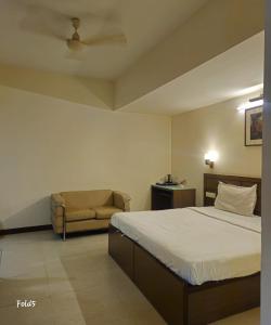 a hotel room with a bed and a chair at Crystal Retreat in Jāmb +11 photos