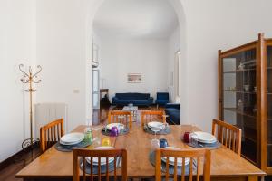 a dining room with a wooden table and chairs at Charming Sea View Loft by Mare&Dimore in Trapani