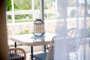 a vase sitting on top of a table on a patio at Homes Eva's garden, Poolside Cozy Havens in Kos in Ágios Dimítrios