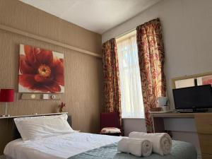 a hotel room with a bed and a television at The Aberford in Blackpool