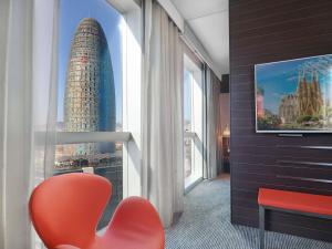 a hotel room with a view of a skyscraper at Novotel Barcelona City in Barcelona