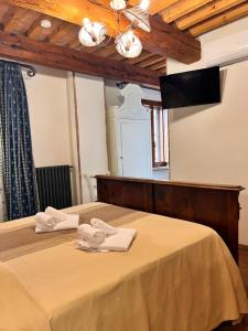 Postel nebo postele na pokoji v ubytování Locanda Corte Arcangeli