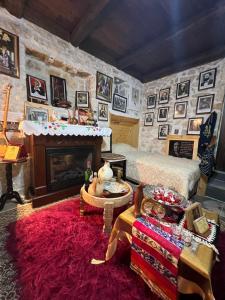 a living room with a fireplace and a red rug at Old town Guesthouse Guri in Berat