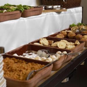 a buffet with several trays of food on a table at Elit Continental Hotel in Baku