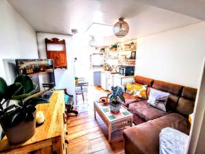 a living room with a couch and a table at Gorgeous Apartment near Bournemouth Beach in Bournemouth