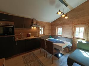 a kitchen and dining room with a table and chairs at Urige Alm in Brandberg