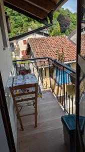 a balcony with a table and a view of a house at Casa Nicolò Vista Lago in Stresa