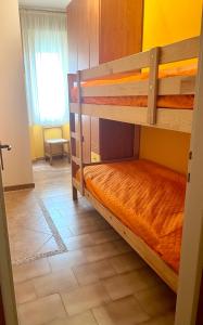 a bedroom with two bunk beds in a room at Appartamento Girasole in Bibione