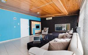a living room with a couch and a laptop on a table at Loft Suit Apart Otel in İskenderun