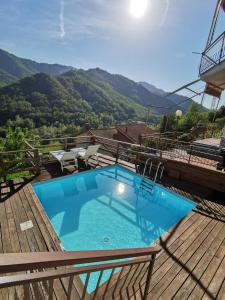 a swimming pool on a deck with mountains in the background at La Casa Bianca by M&G in Orero
