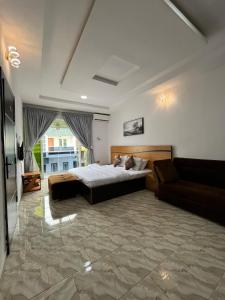 a large bedroom with a bed and a couch at 2 Bedroom Apartment Lekki Greenwood Terrace with extra room in Lekki