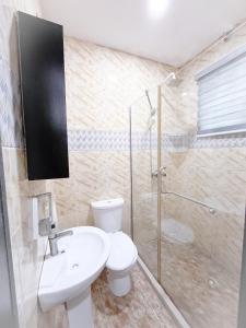 a bathroom with a toilet sink and a shower at 2 Bedroom Apartment Lekki Greenwood Terrace with extra room in Lekki +11 photos