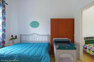 a bedroom with a bed with a blue comforter at Garden house in Amarynthos