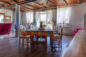 a dining room with a colorful table and chairs at Gierszówka Smak&Relaks in Gietrzwałd