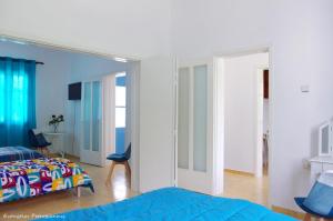 a bedroom with a bed and a large mirror at Garden house in Amarynthos