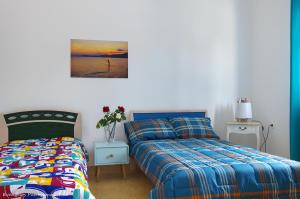 a bedroom with a bed and a bed and a picture at Garden house in Amarynthos +93 photos