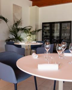 a dining room with tables and chairs and wine glasses at Agriturismo Panacea in Santa Cesarea Terme