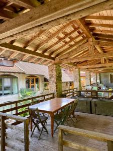 a wooden patio with a wooden table and chairs at Magic Garden - Since 1911 in Luino